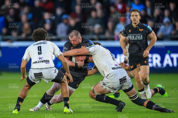 180426 - Ospreys v Hollywoodbets Sharks - United Rugby Championship - Sam Parry of Ospreys is tackled by Emile van Heerden of Hollywoodbets Sharks