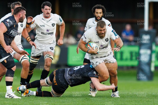 180426 - Ospreys v Hollywoodbets Sharks - United Rugby Championship - Hanro Jacobs of Sharks is tackled by James Ratti of Ospreys