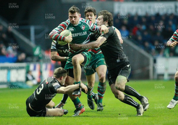 130113 Ospreys v Leicester Tigers - Heineken Cup -Leicester's Adam Thormpstone is tackled by Ospreys' Andrew Bishop(R) and Tom Isaacs