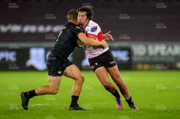 240922 - Ospreys v Emirates Lions - United Rugby Championship - Zander du Plessis of Lions is tackled by Michael Collins of Ospreys