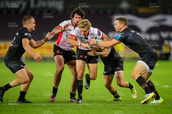 240922 - Ospreys v Emirates Lions - United Rugby Championship - Andries Coetzee of Lions is tackled by George North of Ospreys