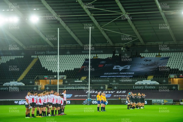 240922 - Ospreys v Emirates Lions - United Rugby Championship - Players pause to remember former BBC journalist, Pontypool and Wales captain Eddie Butler