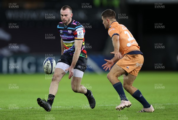 140123 - Ospreys v Montpellier - European Rugby Champions Cup - Cai Evans of Ospreys chips the ball past Anthony Bouthier of Montpellier