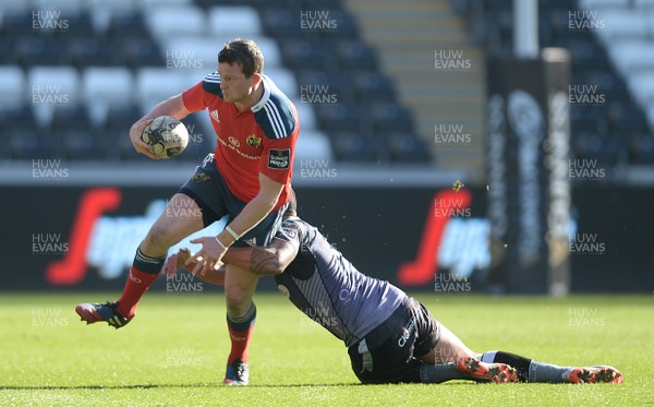 070315 - Ospreys v Munster - Guinness PRO12 -Denis Hurley of Munster is tackled by Josh Matavesi of Ospreys