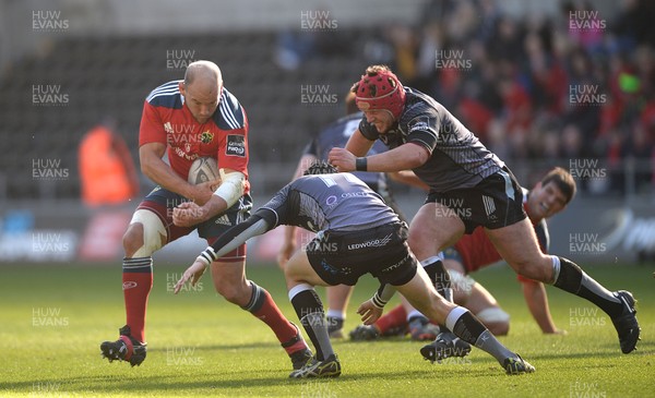 070315 - Ospreys v Munster - Guinness PRO12 -BJ Botha of Munster is tackled by Sam Davies and Scott Otten of Ospreys