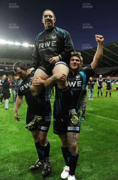 110512 - Ospreys v Munster - RaboDirect PRO12 Play-Off Semi Final -Aaron Jarvis and Richard Hibbard of Ospreys lift Paul James after his last home game for the Ospreys