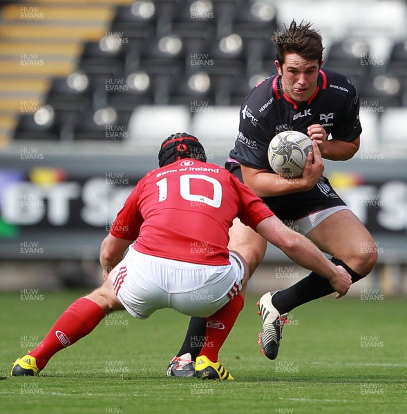 130915 - Ospreys v Munster - Guinness PRO12 - Owen Watkin of Ospreys is tackled by Tyler Bleyendaal of Munster