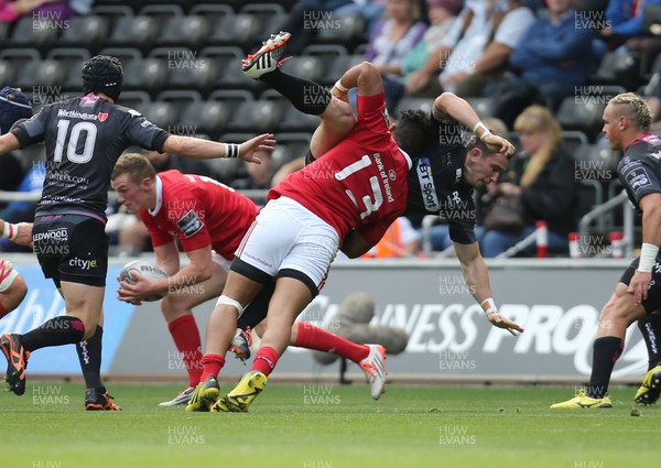 130915 - Ospreys v Munster, Guinness PRO12 - Francis Saili of Munster tackles Kristian Phillips of Ospreys