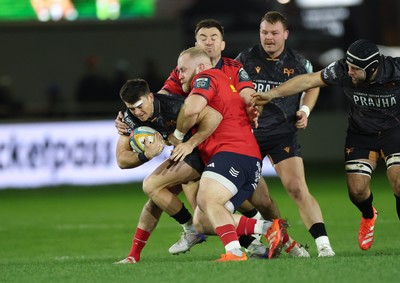 201225 - Ospreys v Munster, United Rugby Championship - Reuben Morgan-Williams of Ospreys is tackled by Jeremy Loughman of Munster