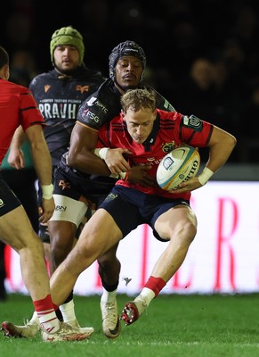201225 - Ospreys v Munster, United Rugby Championship - Mike Haley of Munster is held by Dan Kasende of Ospreys