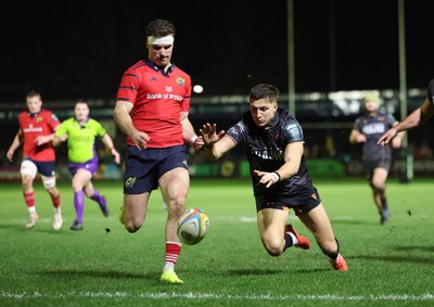 201225 - Ospreys v Munster, United Rugby Championship - Shane Daly of Munster kicks the ball clear to deny Max Nagy of Ospreys the chance to score