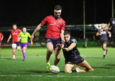 201225 - Ospreys v Munster, United Rugby Championship - Shane Daly of Munster kicks the ball clear to deny Max Nagy of Ospreys the chance to score