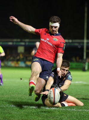 201225 - Ospreys v Munster, United Rugby Championship - Shane Daly of Munster kicks the ball clear to deny Max Nagy of Ospreys the chance to score