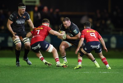 201225 - Ospreys v Munster, United Rugby Championship - Steffan Thomas of Ospreys takes on Alex Kendellen of Munster and Paddy Patterson of Munster