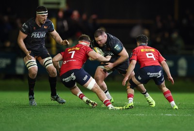 201225 - Ospreys v Munster, United Rugby Championship - Steffan Thomas of Ospreys takes on Alex Kendellen of Munster and Paddy Patterson of Munster