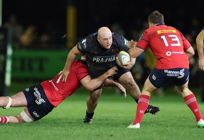 201225 - Ospreys v Munster, United Rugby Championship - Rhys Henry of Ospreys takes on Alex Kendellen of Munster and Tom Farrell of Munster