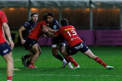 201225 - Ospreys v Munster - United Rugby Championship - Keelan Giles of Ospreys is tackled by Tom Farrell of Munster