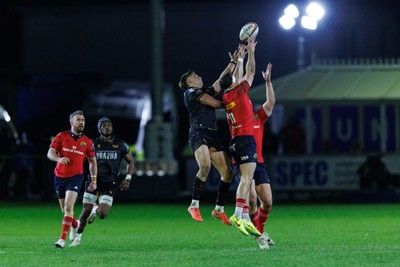 201225 - Ospreys v Munster - United Rugby Championship - Max Nagy of Ospreys and Shane Daly of Munster compete for the ball