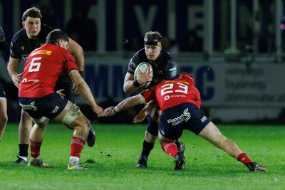 201225 - Ospreys v Munster - United Rugby Championship - Morgan Morse of Ospreys is tackled by John Hodnett of Munster