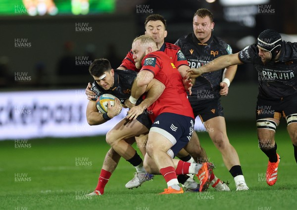 201225 - Ospreys v Munster, United Rugby Championship - Reuben Morgan-Williams of Ospreys is tackled by Jeremy Loughman of Munster