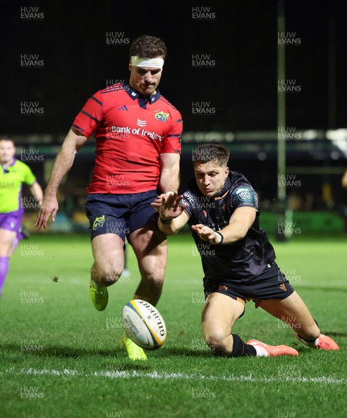 201225 - Ospreys v Munster, United Rugby Championship - Shane Daly of Munster kicks the ball clear to deny Max Nagy of Ospreys the chance to score