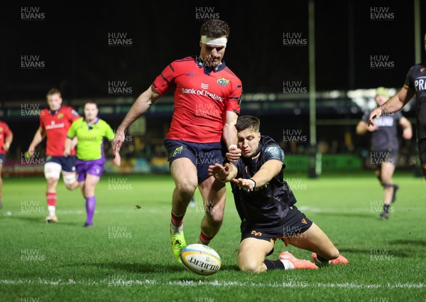 201225 - Ospreys v Munster, United Rugby Championship - Shane Daly of Munster kicks the ball clear to deny Max Nagy of Ospreys the chance to score