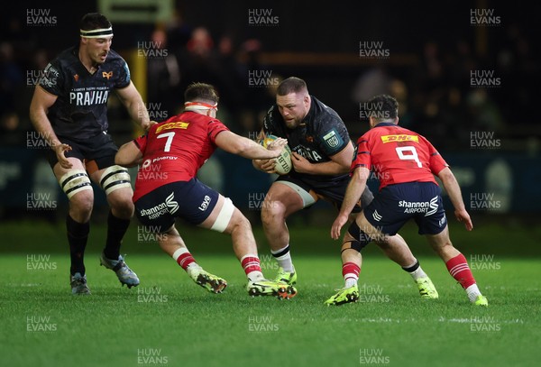 201225 - Ospreys v Munster, United Rugby Championship - Steffan Thomas of Ospreys takes on Alex Kendellen of Munster and Paddy Patterson of Munster