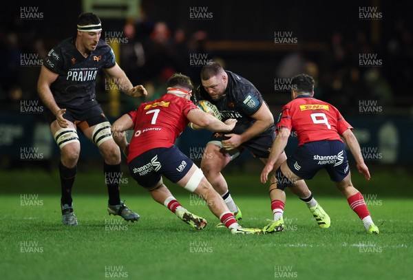 201225 - Ospreys v Munster, United Rugby Championship - Steffan Thomas of Ospreys takes on Alex Kendellen of Munster and Paddy Patterson of Munster