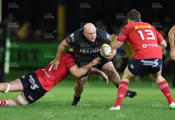 201225 - Ospreys v Munster, United Rugby Championship - Rhys Henry of Ospreys takes on Alex Kendellen of Munster and Tom Farrell of Munster