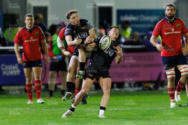 201225 - Ospreys v Munster - United Rugby Championship - Dan Edwards and Reuben Morgan-Williams of Ospreys go up for a high ball