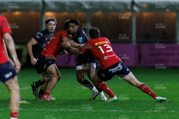 201225 - Ospreys v Munster - United Rugby Championship - Keelan Giles of Ospreys is tackled by Tom Farrell of Munster