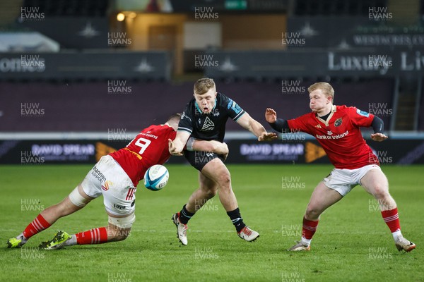 220324 - Ospreys v Munster - United Rugby Championship - Keiran Williams of Ospreys loses the ball as he is tackled by Jack O’Donoghue of Munster