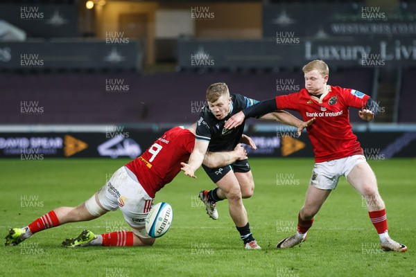 220324 - Ospreys v Munster - United Rugby Championship - Keiran Williams of Ospreys loses the ball as he is tackled by Jack O’Donoghue of Munster