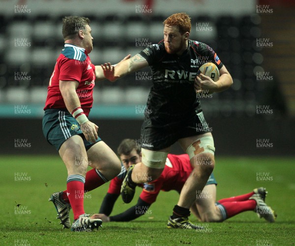 230214 - Ospreys v Munster - RaboDirect PRO12 - Dan Baker of Ospreys is tackled by Dave Kilcoyne of Munster 