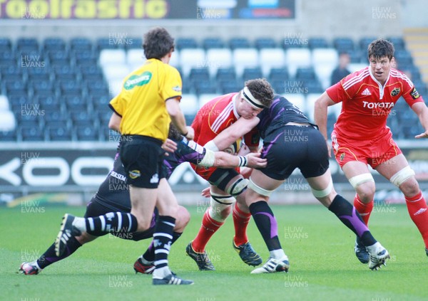 23.04.11 Ospreys v Munster - Magners League - Munster's James Coughlan is tackled by Ospreys' Adam Jones(L) & Alun-Wyn Jones. 