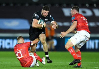 231021 - Ospreys v Munster - United Rugby Championship - Alex Cuthbert of Ospreys is tackled by Jack Crowley of Munster