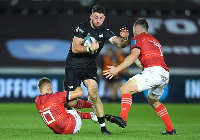 231021 - Ospreys v Munster - United Rugby Championship - Alex Cuthbert of Ospreys is tackled by Jack Crowley and Peter O’Mahony of Munster