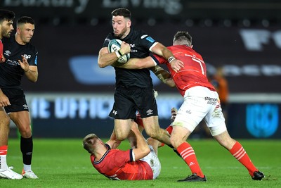 231021 - Ospreys v Munster - United Rugby Championship - Alex Cuthbert of Ospreys is tackled by Jack Crowley and Peter O’Mahony of Munster