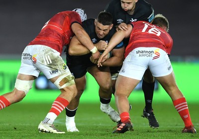 231021 - Ospreys v Munster - United Rugby Championship - Gareth Thomas of Ospreys is tackled by Fineen Wycherley and Keynan Knox of Munster