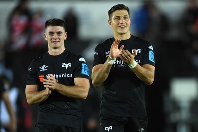 231021 - Ospreys v Munster - United Rugby Championship - Reuben Morgan-Williams and Max Nagy of Ospreys at the end of the game