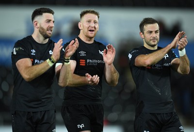 231021 - Ospreys v Munster - United Rugby Championship - Alex Cuthbert, Bradley Davies and Stephen Myler of Ospreys at the end of the game