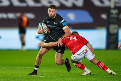 231021 - Ospreys v Munster - United Rugby Championship - Alex Cuthbert of Ospreys is tackled by Craig Casey of Munster