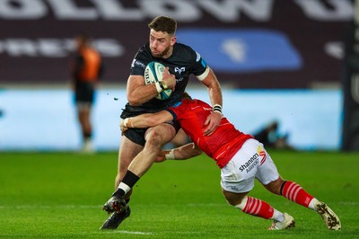 231021 - Ospreys v Munster - United Rugby Championship - Alex Cuthbert of Ospreys is tackled by Craig Casey of Munster