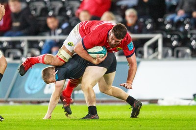 231021 - Ospreys v Munster - United Rugby Championship - Jean Kleyn of Munster is tackled by Keiran Williams of Ospreys