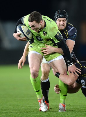 180115 - Ospreys v Northampton Saints - European Rugby Champions Cup -George North of Northampton is tackled by James King and Scott Baldwin of Ospreys