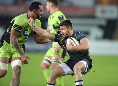 180115 - Ospreys v Northampton Saints - European Rugby Champions Cup -Rhys Webb of Ospreys is tackled by Samu Manoa of Northampton