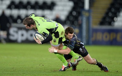 180115 - Ospreys v Northampton Saints - European Rugby Champions Cup -Stephen Myler of Northampton is tackled by Dan Biggar of Ospreys