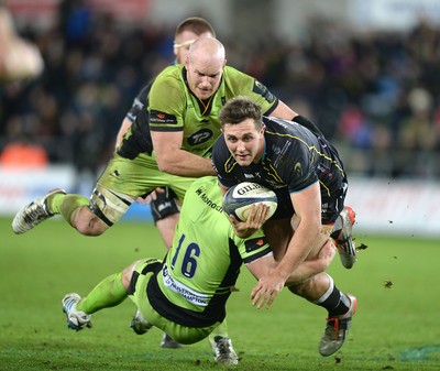 180115 - Ospreys v Northampton Saints - European Rugby Champions Cup -Ashley Beck is tackled by Mike Haywood and Sam Dickinson of Northampton