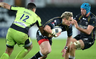 180115 - Ospreys v Northampton Saints - European Rugby Champions Cup -Hanno Dirksen of Ospreys is tackled by Luther Burrell of Northampton