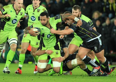 180115 - Ospreys v Northampton Saints - European Rugby Champions Cup -Samu Manoa of Northampton is tackled by Marc Thomas and Justin Tipuric of Ospreys